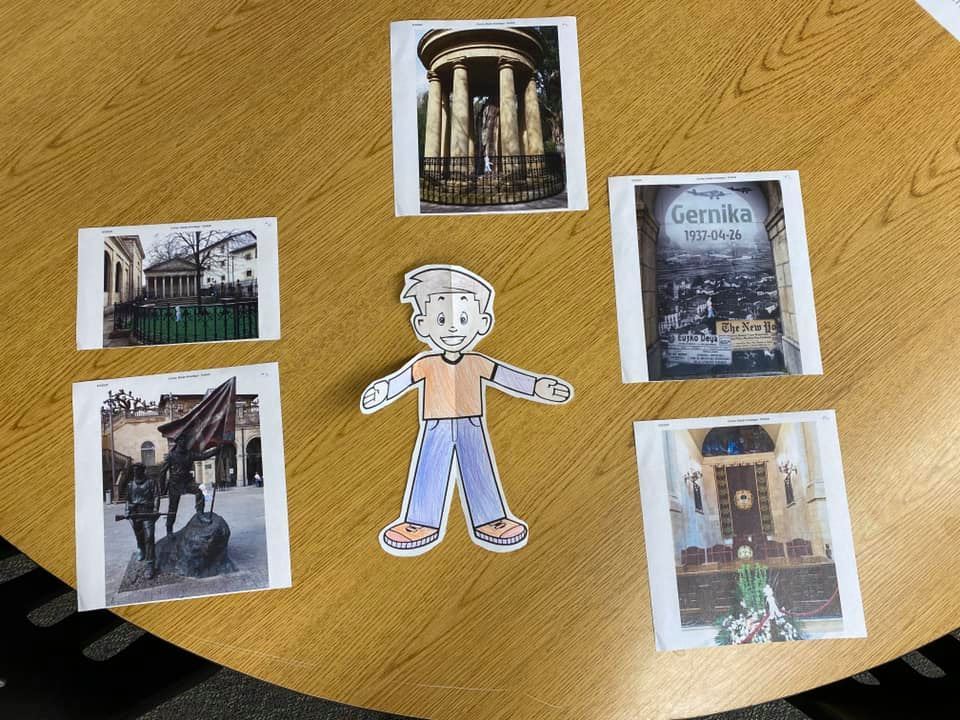 Flat Stanley on the table with pictures from Spain